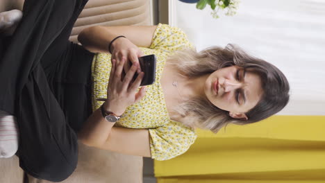Vertical-video-of-Disappointed-young-woman-texting.